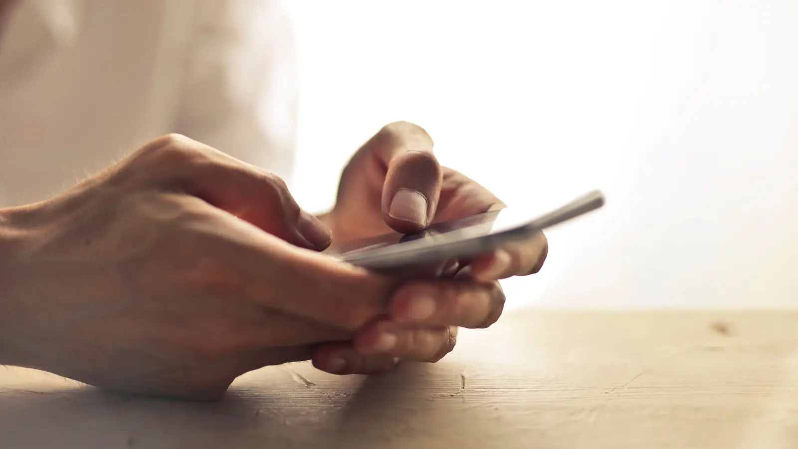 Hands filling out an online loan request on a smartphone