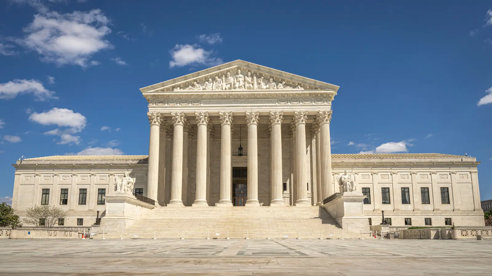 Front of the U.S. Supreme Court building under a blue sky