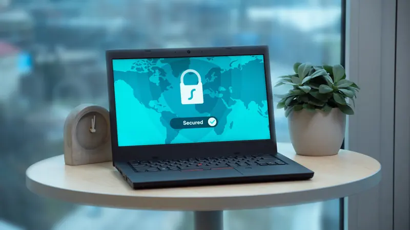 Laptop showing a secured connection padlock on a table
