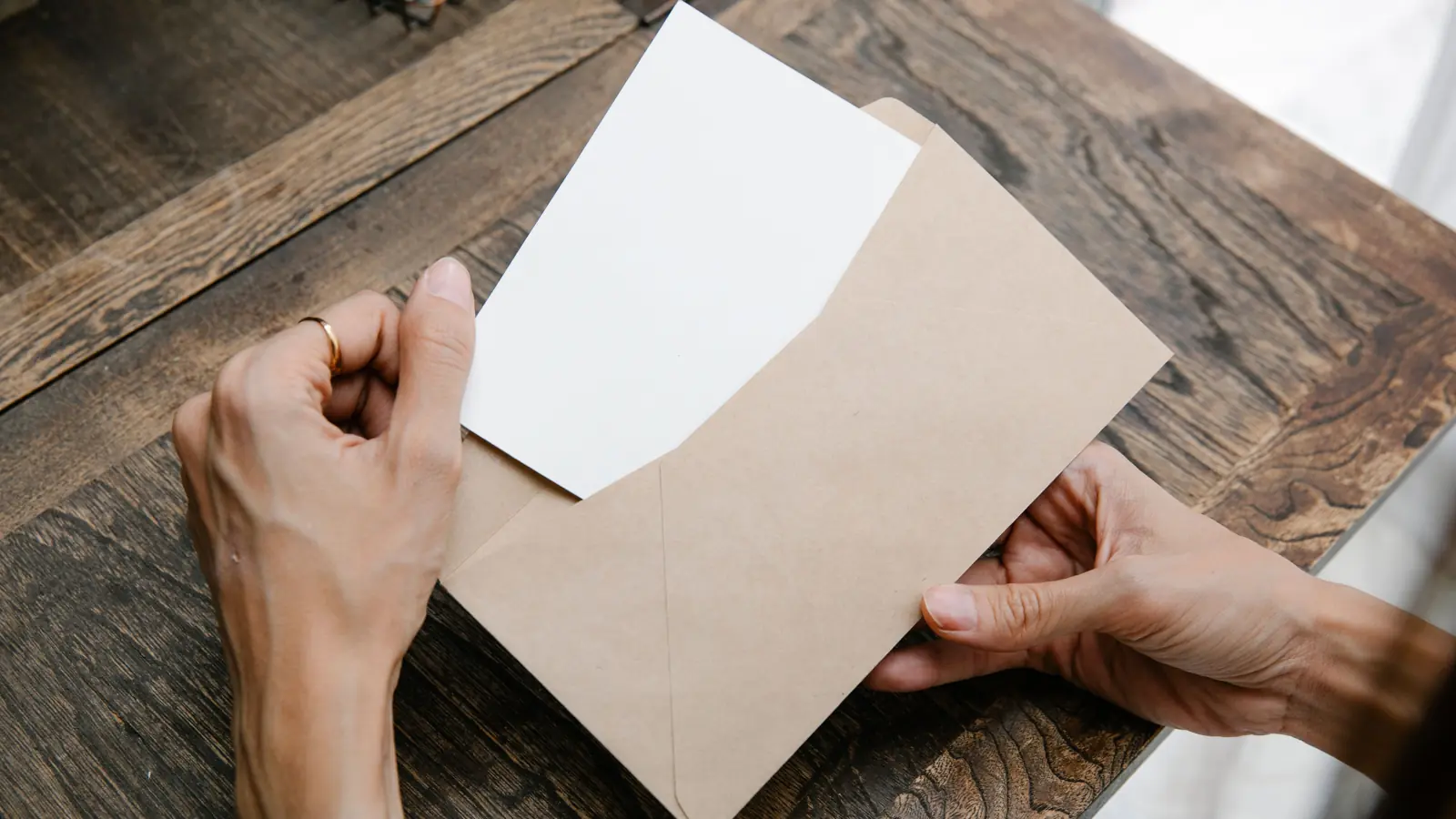 Hands opening an envelope with a pre-approved offer letter